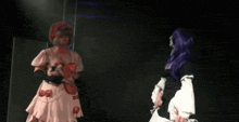 a woman in a pink dress with bows on the back is standing next to another woman