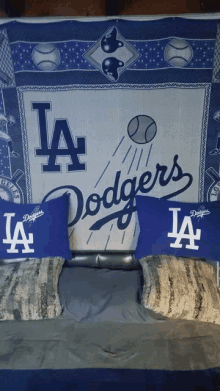 a bed with a dodgers pillow and a dodgers blanket