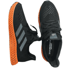 a pair of black and orange adidas future craft 4 shoes