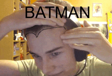 a man with batman written on his head