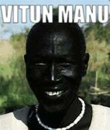 a man with black skin is smiling and has the name vitun manu written on his face