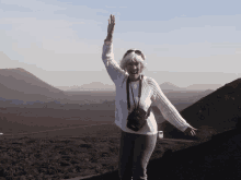 a woman in a white sweater with a black bag that says ' eos ' on it