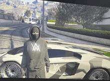 a man wearing a mask and a hoodie with the letter w on it stands in front of a car