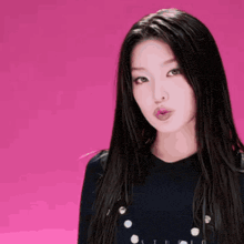a woman with long black hair is wearing a black shirt that says studio on it