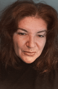 a close up of a woman 's face with red hair and freckles