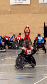 a group of people in wheelchairs are playing a game in front of a sign that says sundern city council