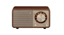 a wooden radio with a gold knob that says volume