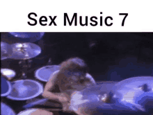 a man is playing drums in front of a drum set with the words sex music 7 on the bottom .