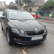 a black skoda car with a license plate that says aa 587sx