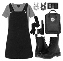 a black overall dress with a grey shirt and a black kanken backpack