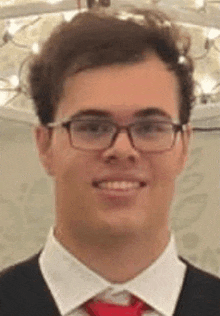 a young man wearing glasses , a white shirt and a red tie is smiling .