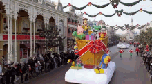 a christmas parade with a float that says ' disneyland ' on it