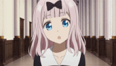 a girl with pink hair and blue eyes has a bow on her hair