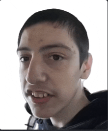 a close up of a young man 's face with a white background .