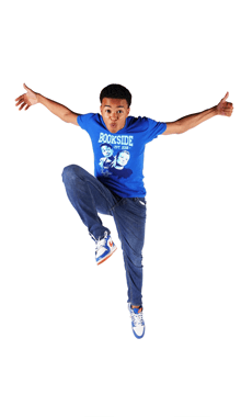 a boy wearing a blue shirt that says bookside jumps in the air