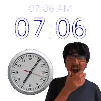 a man with glasses stands in front of a clock that says 7:06 am