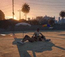 a man and a woman laying on a beach with umbrellas in the background