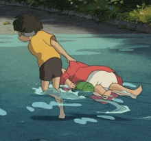 a boy in a yellow shirt is pulling a girl in a red shirt out of the water