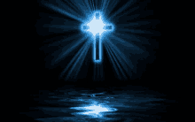 a blue cross is reflected in the water with a black background