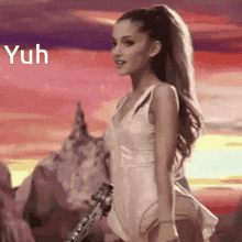 a woman in a white dress is holding a guitar in front of a sunset with the word yuh above her