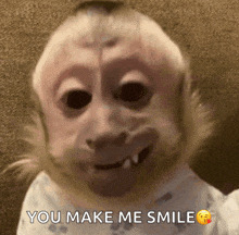 a baby monkey is smiling with the words " you make me smile " next to it