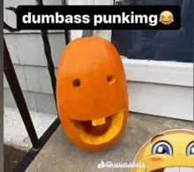 a pumpkin with a face carved into it and the words dumbass punking