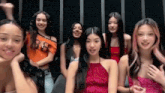 a group of young women are sitting next to each other in a room .