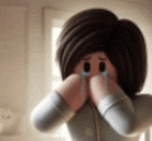 a cartoon character is crying while covering her face with her hands