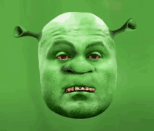 a shrek mask with red eyes on a green background