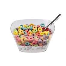 a bowl of fruit loops cereal with milk and a spoon