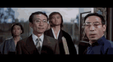 a group of men standing next to each other in a room .