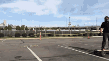 a man wearing a mask is riding a skateboard in a parking lot with a sign that says ' no parking '