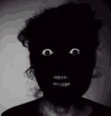 a black and white photo of a person 's face with a very scary look on their face .