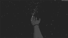 a person 's hand is reaching for a star in the sky .