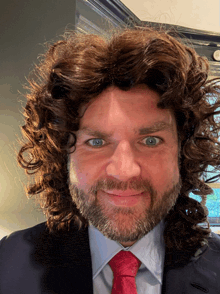 a man with a beard wearing a suit and tie
