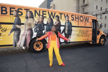 a woman is standing in front of a bus that says best new tv show