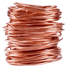 a stack of copper wire on a white surface