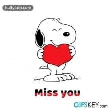 snoopy is holding a red heart and says `` miss you '' .