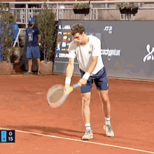 a man is holding a tennis racquet on a tennis court with a sign that says cachantun in the background