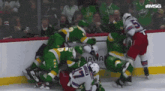 a hockey player with the number 17 on his jersey is surrounded by other players