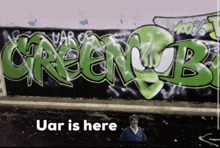 a wall with graffiti on it that says green mob and uar is here