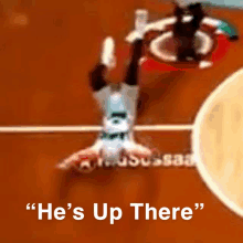 a basketball player is upside down with the words " he 's up there " above him