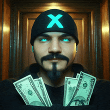 a man with a beard and a hat with an x on it is holding a bunch of money