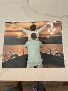 a picture of two men on a boat with the word photo on the bottom right