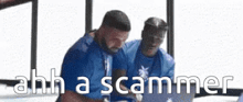 two men are sitting in front of a laptop computer with the words `` ahh a scammer '' written on the screen .