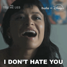 a woman is laughing with the words i don 't hate you behind her