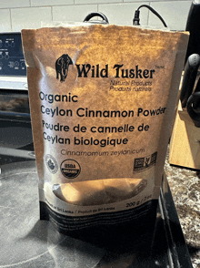 a bag of wild tusker organic ceylon cinnamon powder sits on a counter