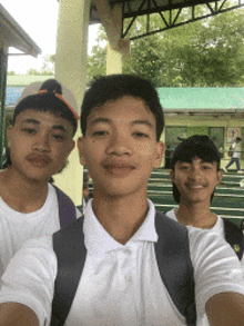 three young men are posing for a picture together