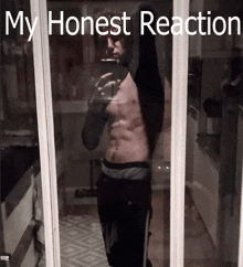 a shirtless man taking a selfie in front of a mirror with the words my honest reaction below him