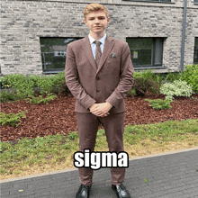 a man in a suit and tie is standing in front of a brick building with sigma written on the sidewalk in front of him